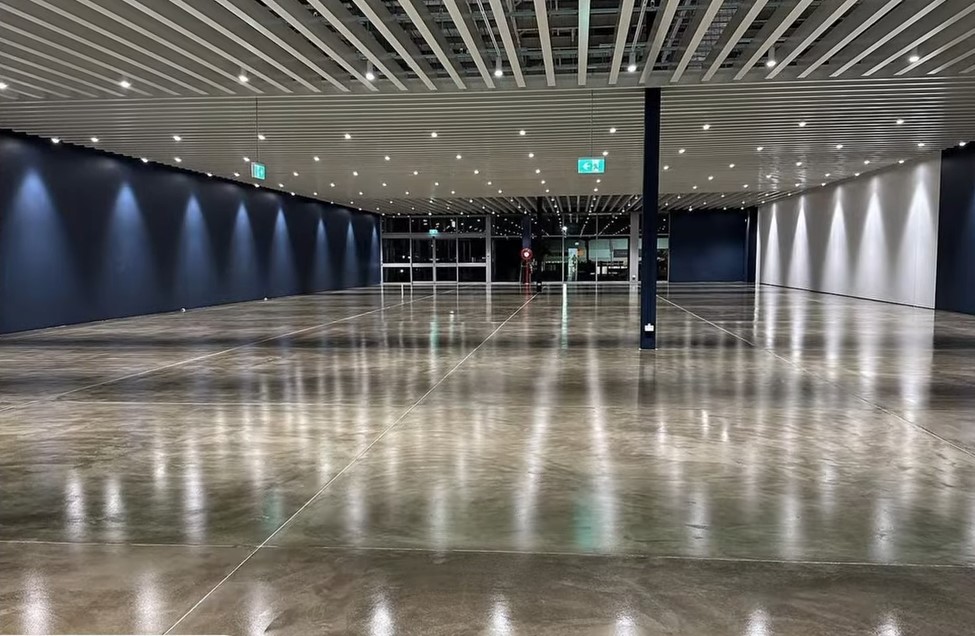 empty space with silver brown floor and blue walls