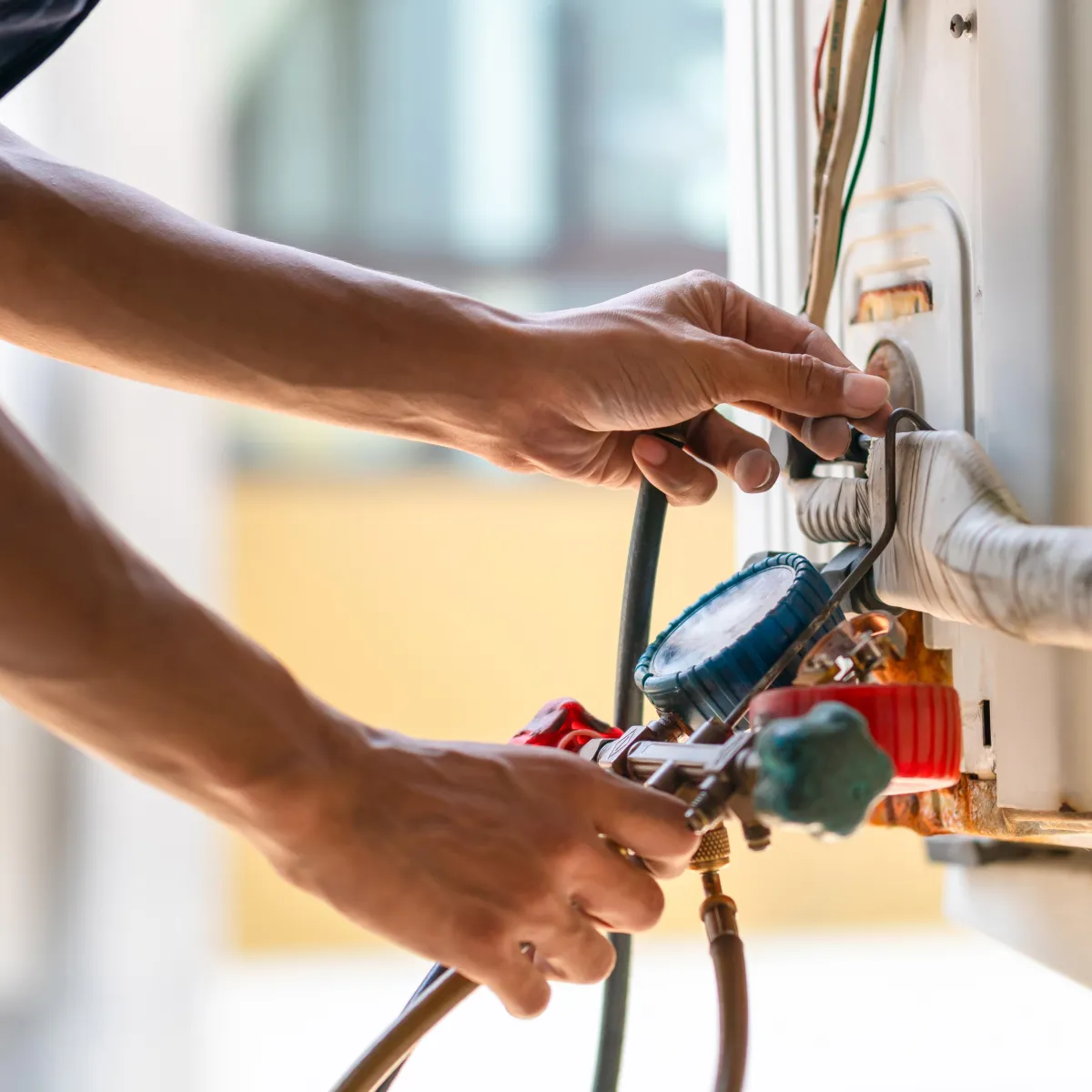 Technician connecting gauges for AC Tune Up Inspection. Soligo Air keeps Central Florida systems efficient with expert seasonal care
