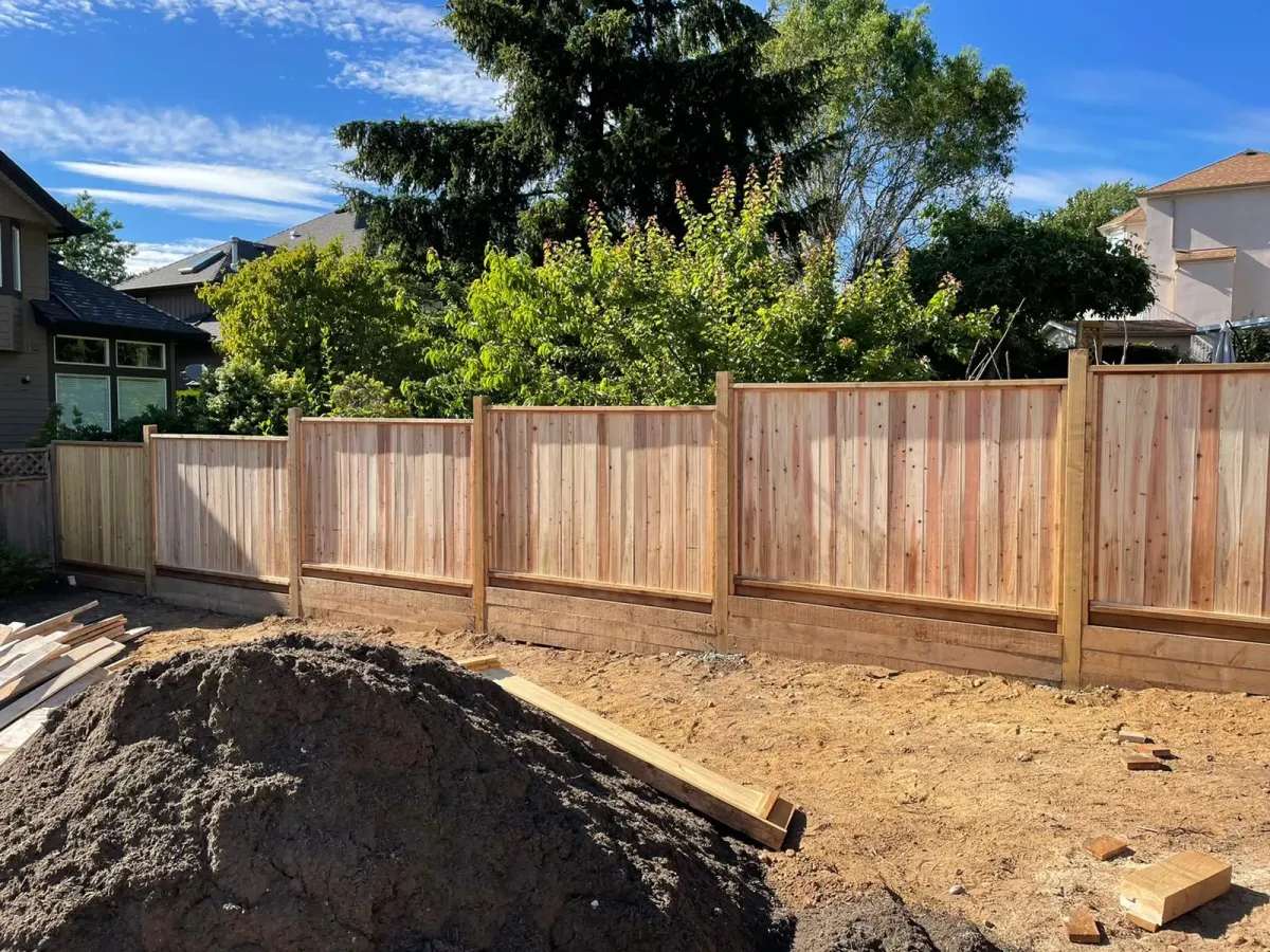 Professional fence builders installing a privacy fence