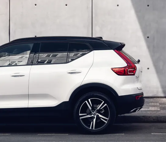 A shiny white car with a tinted window