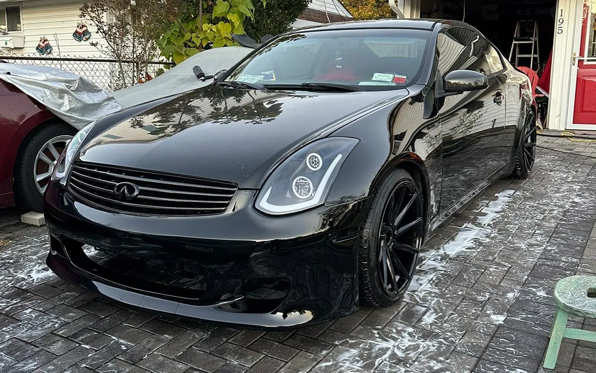 A person polishing the exterior of a car, enhancing its shine and appearance