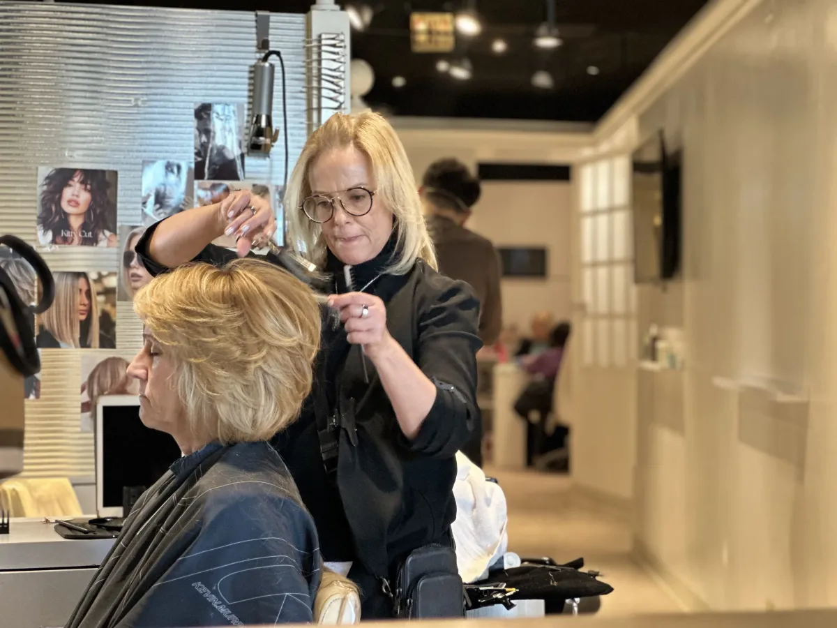 Stylist applying highlights at Ida's Salon