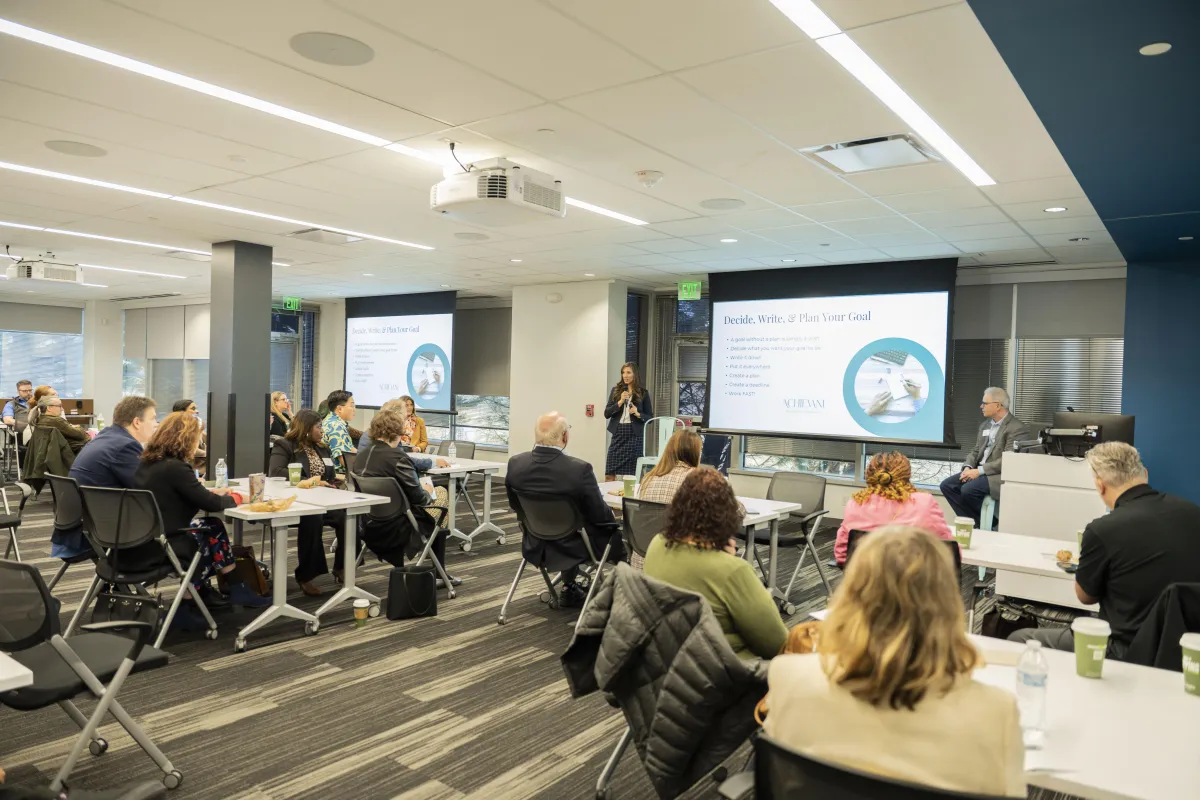 man in blue denim jacket sitting on brown sofa chair