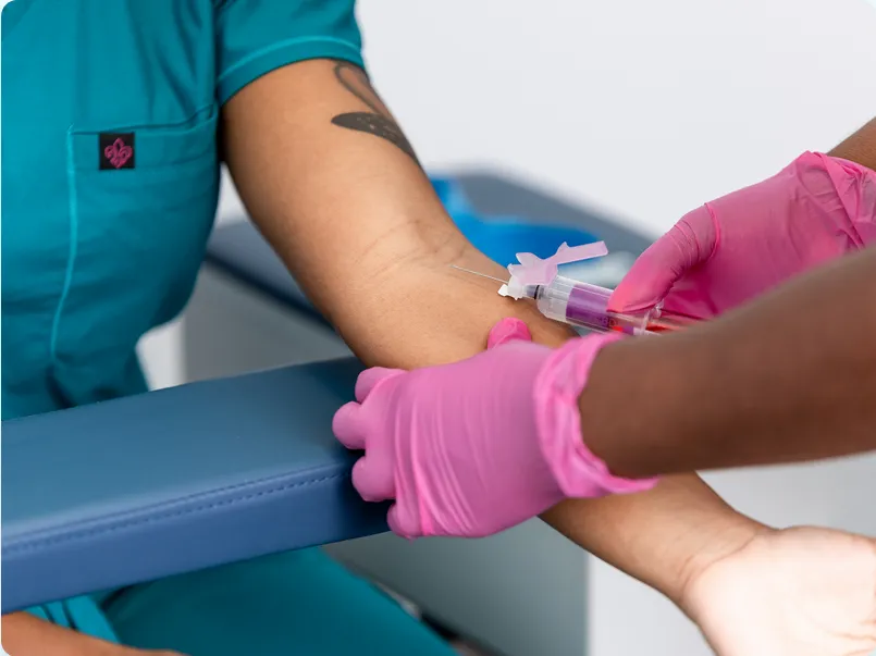 Phlebotomy students practicing patient care skills in Detroit training class