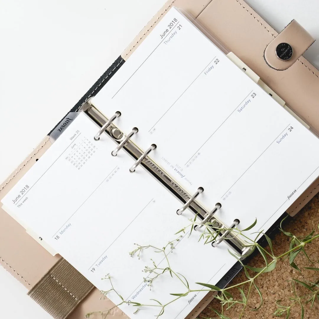 Open appointment planner with greenery representing regular scheduled health appointments at Solutions Functional Medicine Centre