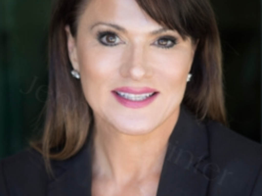 Portrait of Alice Diambri Robinson, Luxury Real Estate Advisor with Realogics Sotheby’s International Realty, wearing a black blazer and smiling confidently.