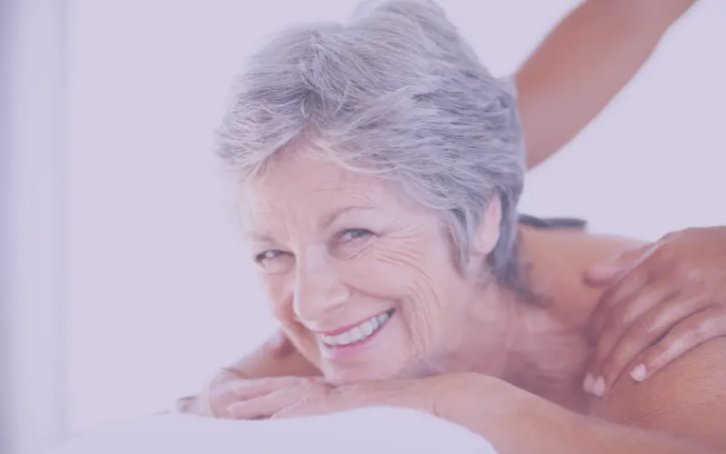 Woman receiving a relaxing massage with gentle hands on her forehead, emphasizing spa services like Post Op Massage and Swedish Massage offered by Spa Mobile.