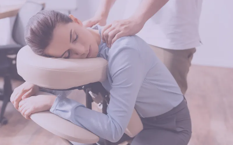 Massage therapist performing deep tissue massage on a client's shoulder, emphasizing relaxation and wellness in a spa setting.