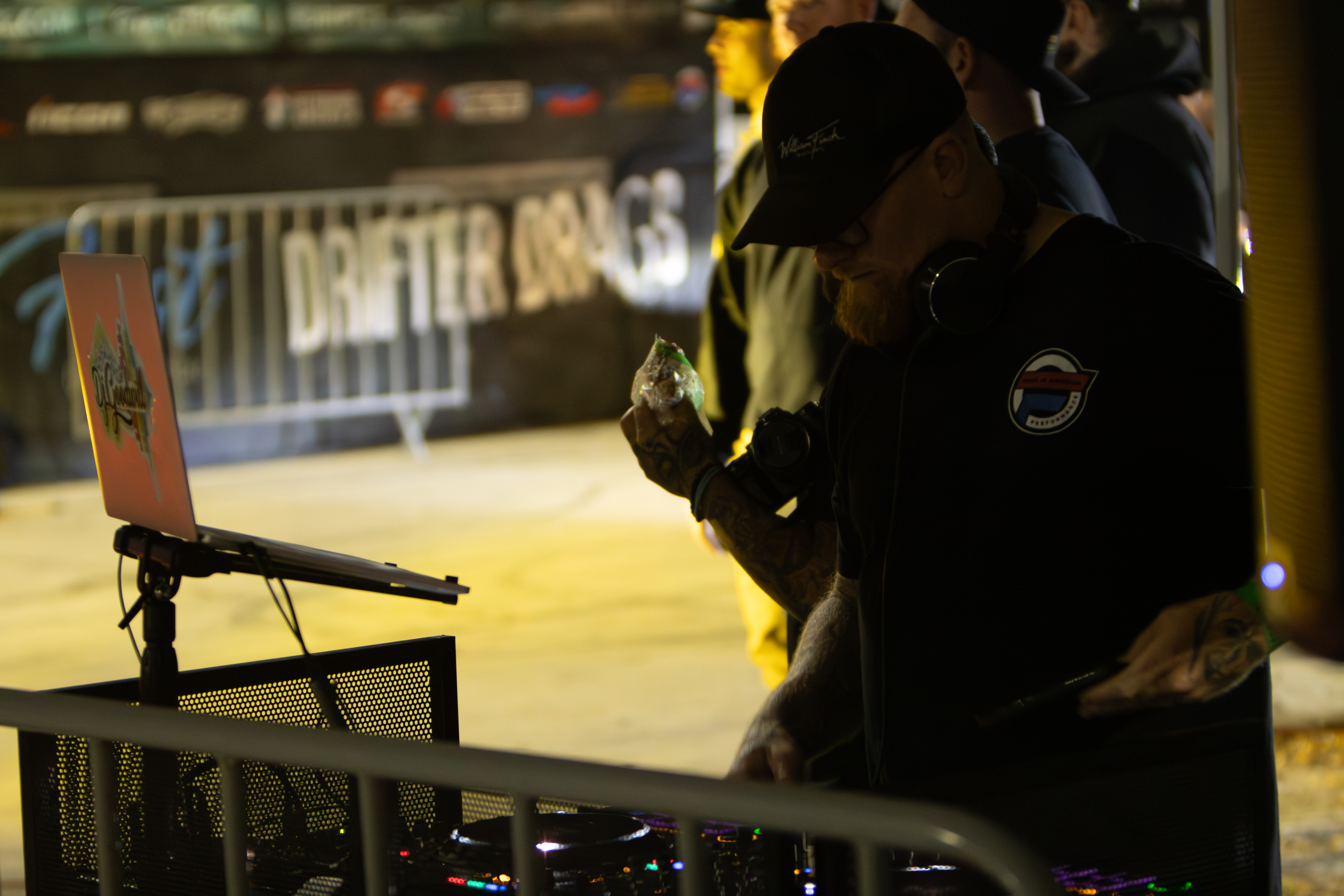 Close-up of a mastering engineer at work, focused on a studio monitor with cyan metering glow and gold accent highlights; hands on control surface, dramatic low-key lighting, photorealistic, emphasizes technical mastery and attention to detail.