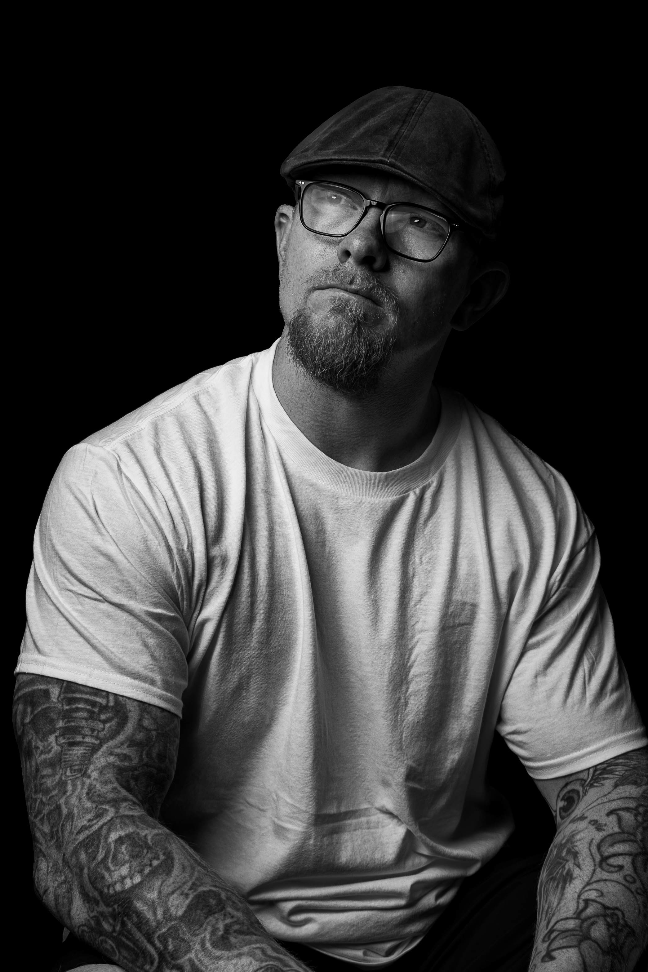 Studio still of a fashion shoot with charcoal backdrop, model illuminated with cyan rim and gold key fill; camera and lights visible, minimalistic set, high-contrast editorial aesthetic demonstrating premium commercial photography skills.