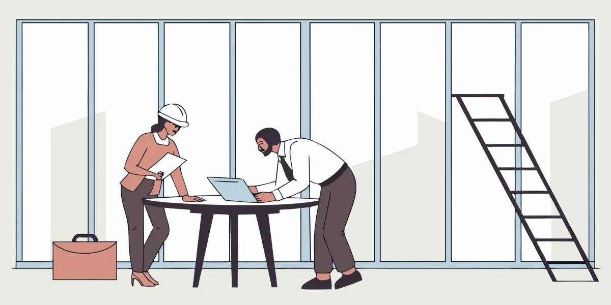 An office renovation contractor meets with a client to review project blueprints.