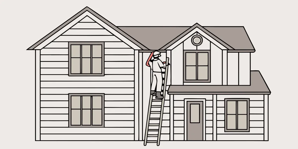 Worker on a ladder performing a vinyl siding replacement on a house.