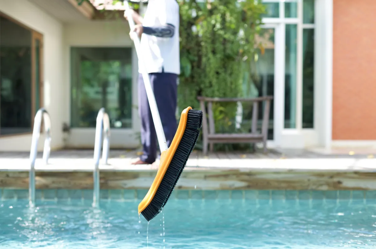 woman in black one piece swimsuit jumping on swimming pool during daytime