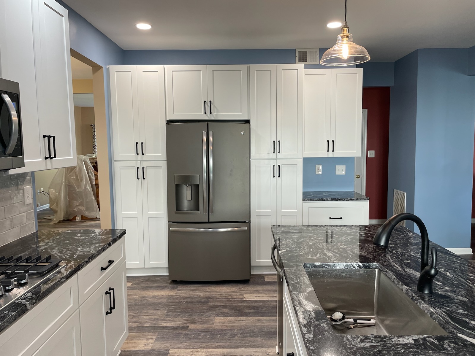 Kitchen with stainless steel refrigerator 