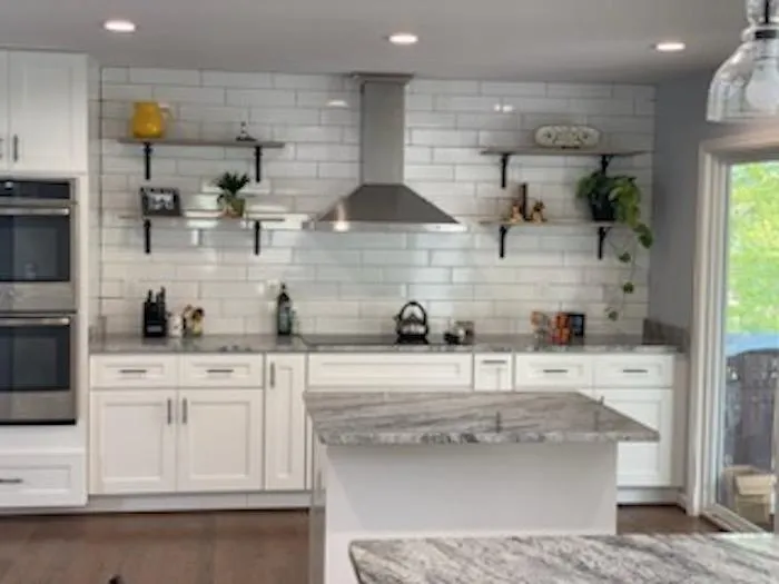 a kitchen with white cabinets and white counter top