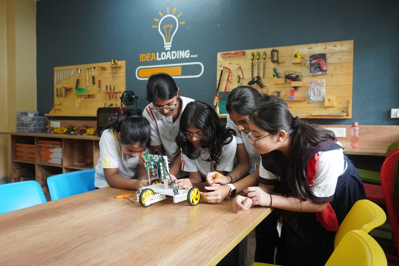 Students in a hands-on AI and robotics lab session at a Grobots school