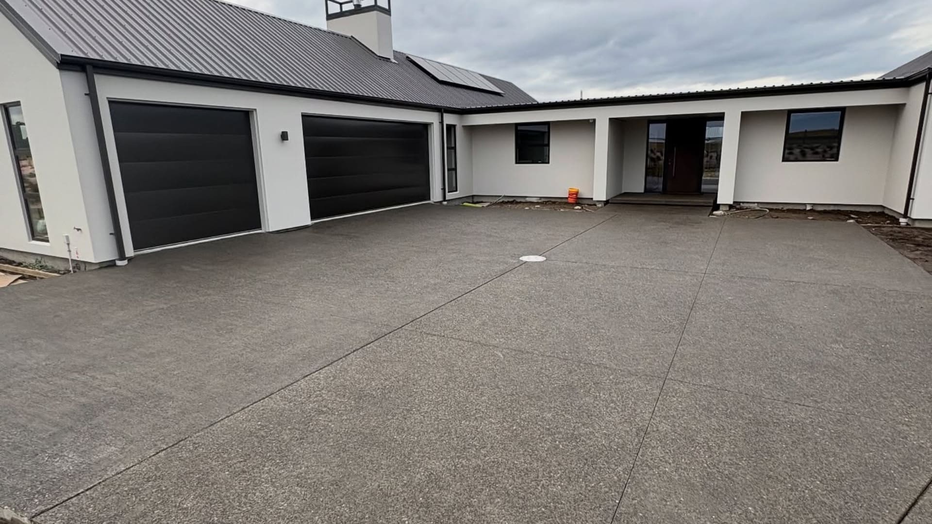 Decorative exposed aggregate concrete driveway for a residential property