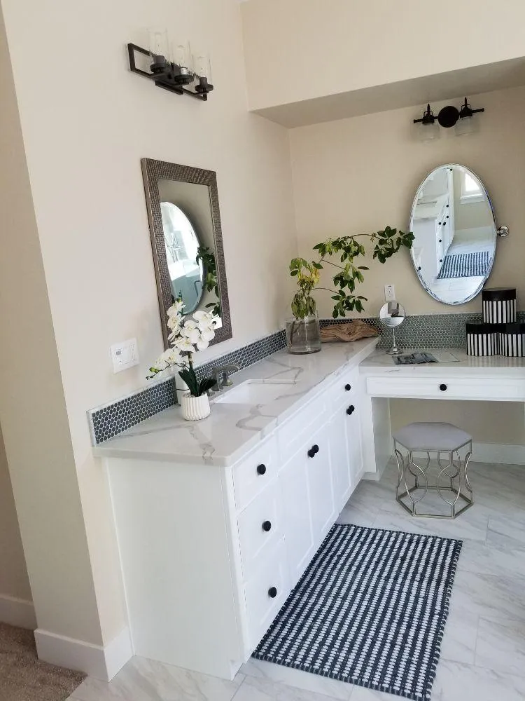 Master bathroom renovation with new vanity, lighting, and decor