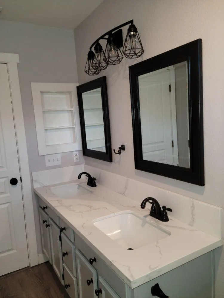 New mirrors, custom built-in shelves, and new lighting in bathroom remodel