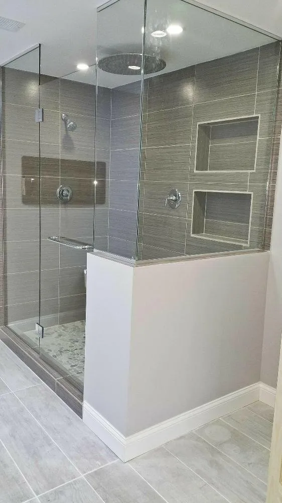 Bathroom remodel with glass shower and modern tile design