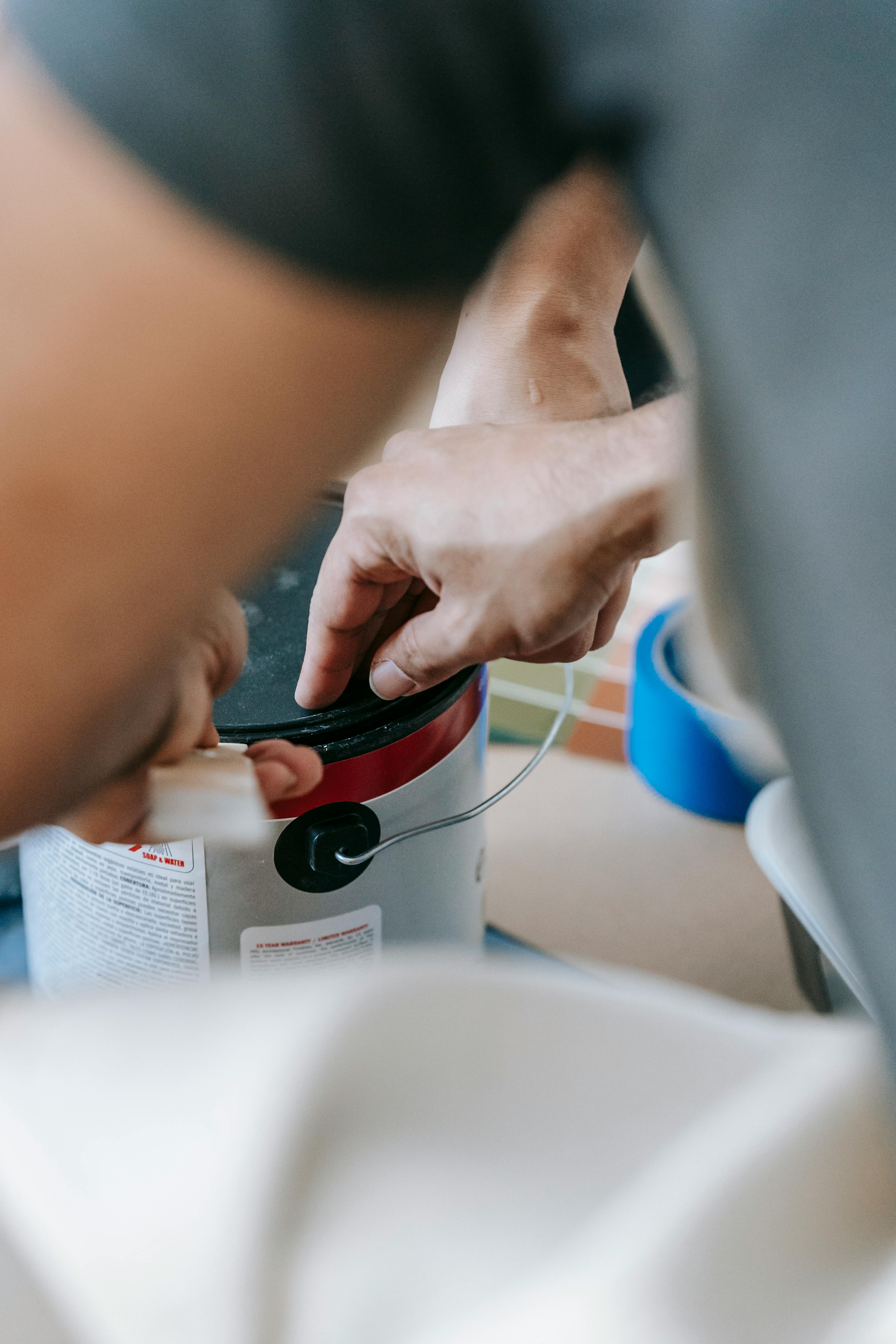 someone opening dark green paint can