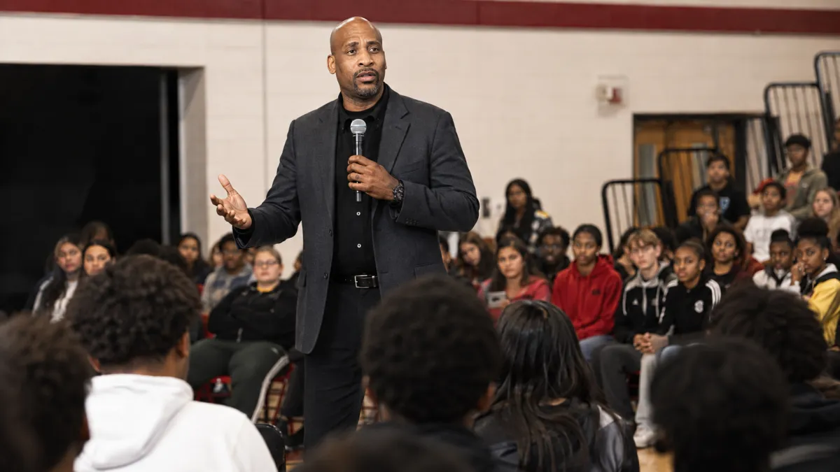 Kevin speaking to students with a microphone