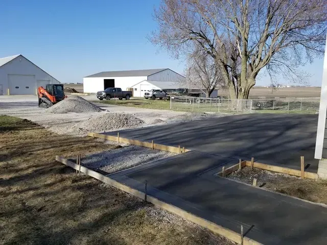 Concrete apron and pad installation at agricultural facility by Quick Concrete Solutions Iowa