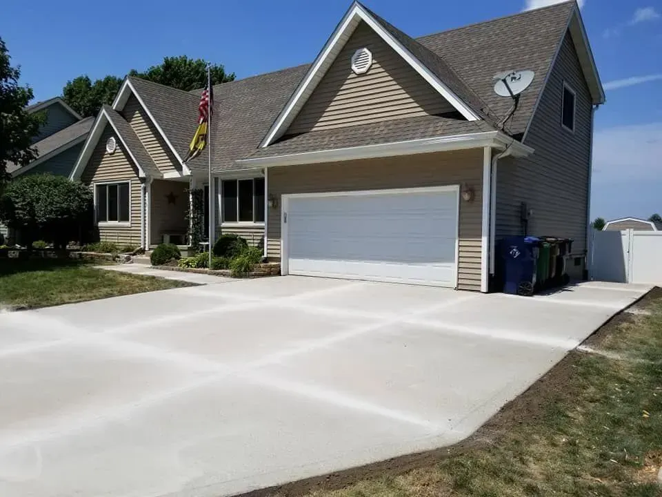 Wide residential concrete driveway installation at Iowa home by Quick Concrete Solutions Central Iowa