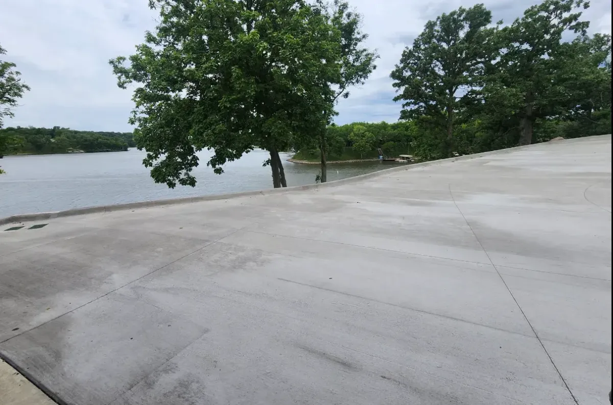 Large concrete slab installation at lakefront property with water view by Quick Concrete Solutions Iowa