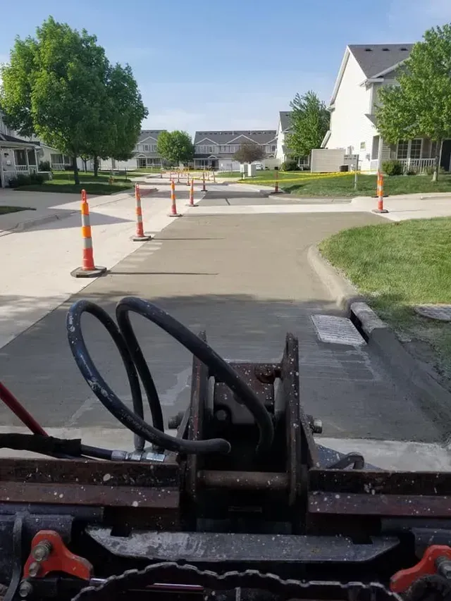 Residential street concrete repair in progress from equipment view by Quick Concrete Solutions Central Iowa