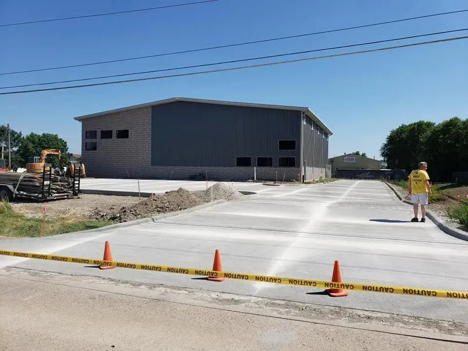 Freshly poured commercial concrete parking area at warehouse by Quick Concrete Solutions Central Iowa
