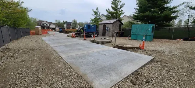 Concrete pad installation at residential utility site by Quick Concrete Solutions Iowa