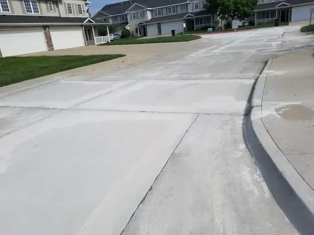 Concrete driveway and street apron installation in residential neighborhood by Quick Concrete Solutions Iowa