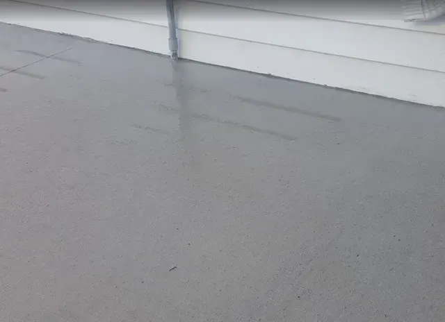 Freshly poured smooth concrete slab for residential garage or patio by Quick Concrete Solutions Iowa