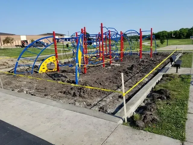 Concrete border and flatwork installation around school playground by Quick Concrete Solutions Central Iowa