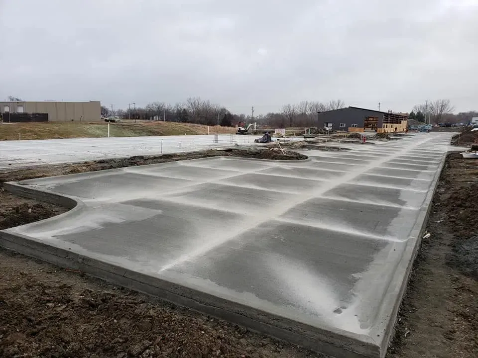 Fresh commercial concrete slab with control joints at new development by Quick Concrete Solutions Iowa