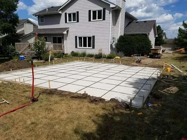 Large backyard concrete slab with control joints by Quick Concrete Solutions Central Iowa