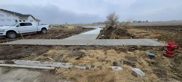 New concrete driveway approach at rural construction site by Quick Concrete Solutions Iowa