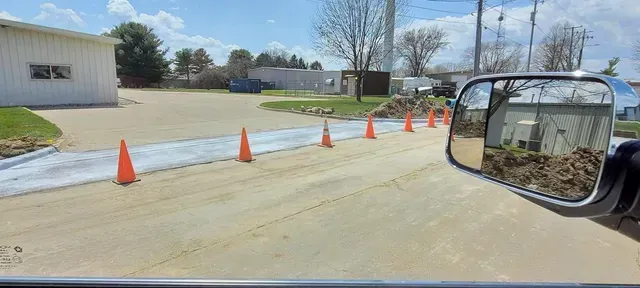 Commercial concrete parking lot repair curing with traffic cones by Quick Concrete Solutions Iowa