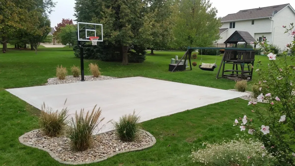 Residential concrete basketball court installation in backyard by Quick Concrete Solutions Central Iowa