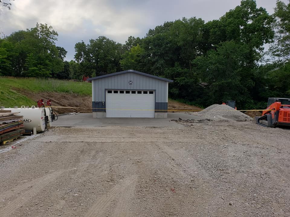 Concrete apron and pad installation at rural outbuilding by Quick Concrete Solutions Central Iowa