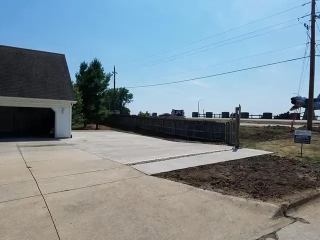 Residential concrete driveway expansion at single car garage by Quick Concrete Solutions Iowa