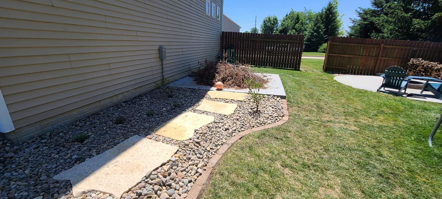 Decorative concrete stepping stone pathway with river rock landscaping by Quick Concrete Solutions Central Iowa
