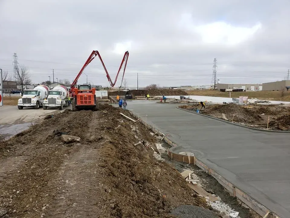 Large commercial concrete parking lot pour with pump trucks by Quick Concrete Solutions Central Iowa