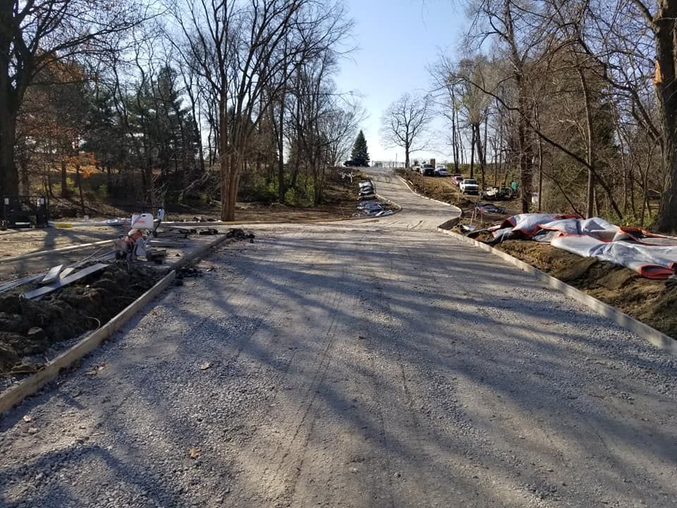 Concrete driveway subbase preparation through wooded property by Quick Concrete Solutions Iowa