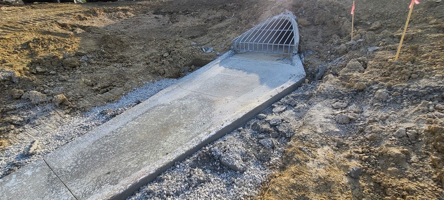 Concrete drainage channel and grate installation by Quick Concrete Solutions Central Iowa
