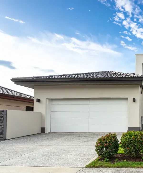 Modern house with a freshly cleaned concrete driveway and garage entrance