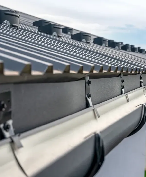 Close-up of a clean metal roof gutter system after professional maintenance 