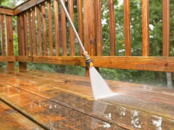 Close-up of pressure washing outdoor tile steps to remove dirt and stains