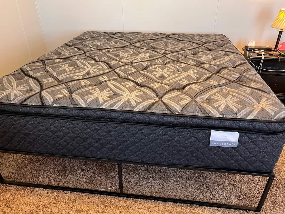 A black super pillow top mattress with white crisscross pattern on top made by Lunessence and Coricana.